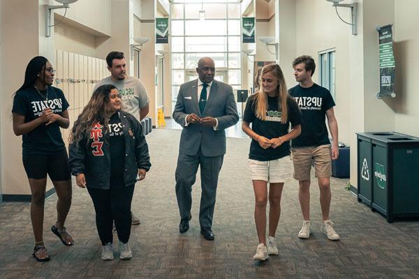 Dr. Bennie Harris walking with students